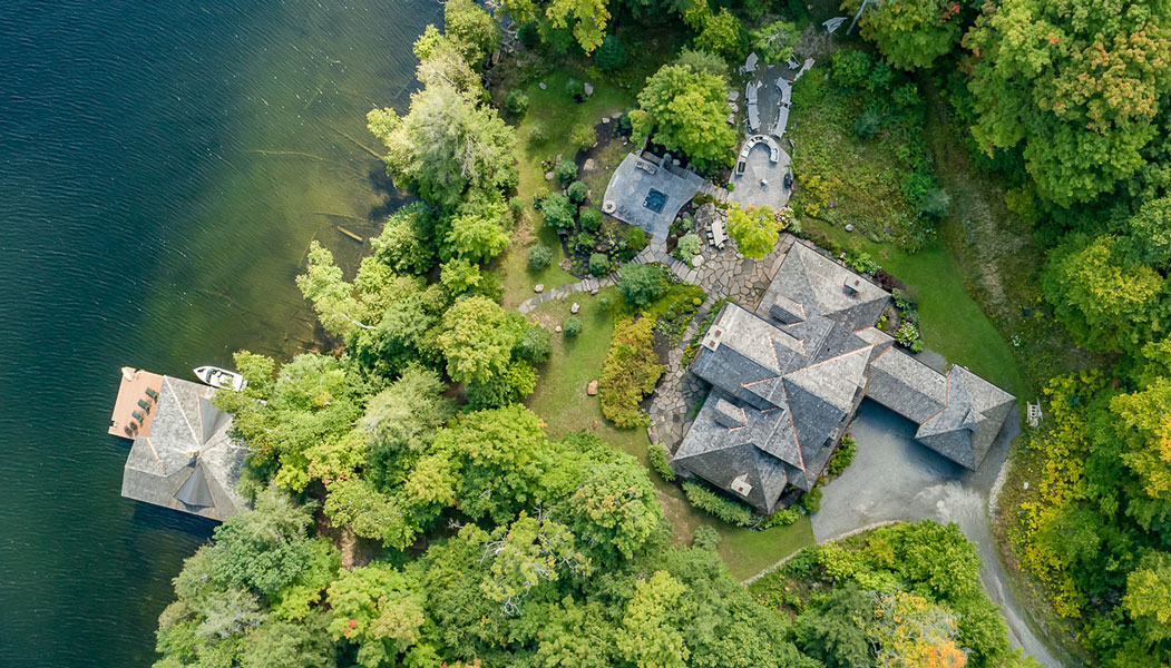 Aerial image of a luxury waterfront property surrounded by lush greenery.