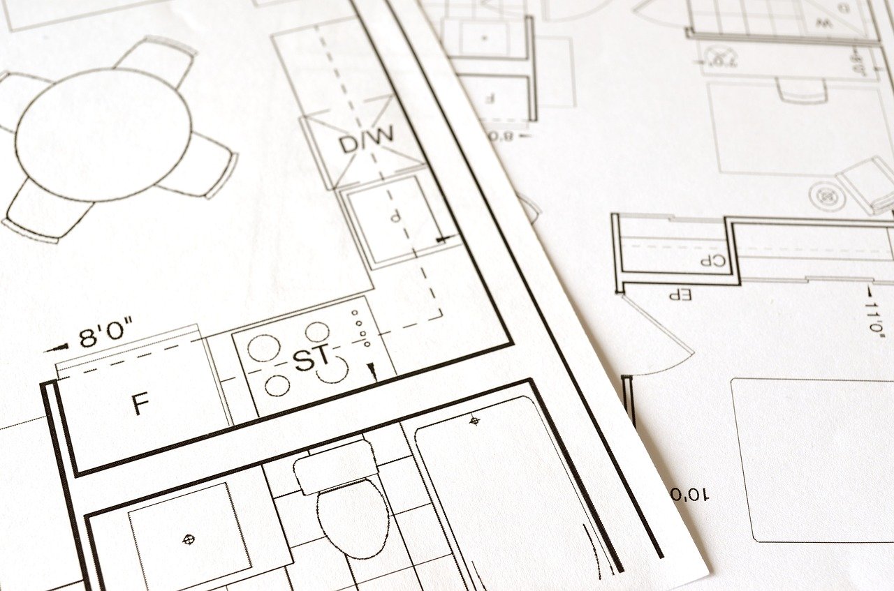 Paper with condo floor plans for client review.