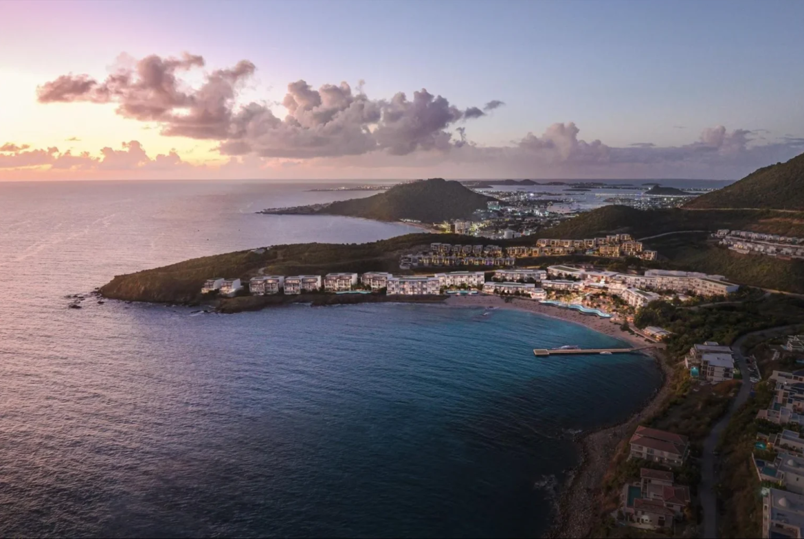 Twilight over Vie L'Ven luxury resort, showcasing the expansive property along the curving coastline of St. Maarten.