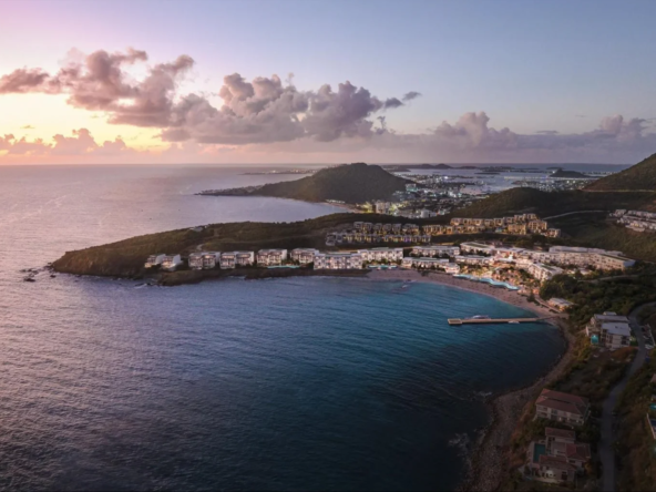 Twilight over Vie L'Ven luxury resort, showcasing the expansive property along the curving coastline of St. Maarten.